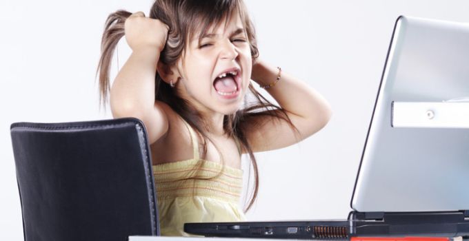 girl pulling hair in front of laptop