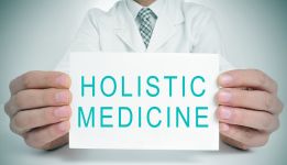 doctor holding holistic medicine sign